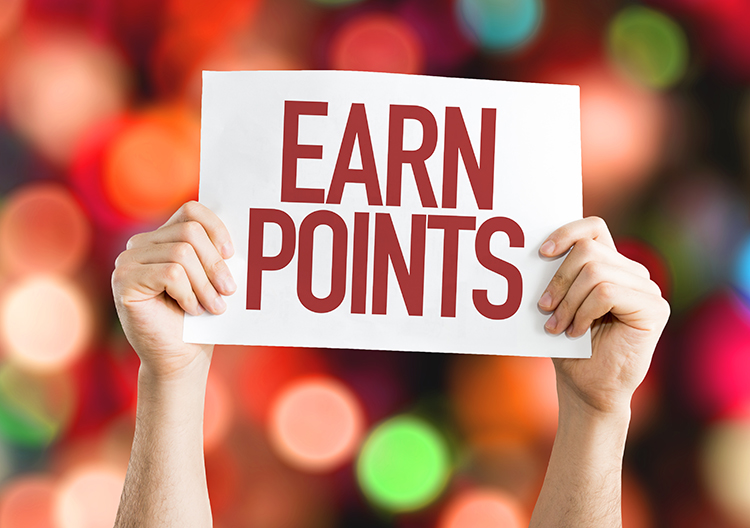 Earn points with every purchase! White hands hold sign that reads "Earn Points" in front of a colorful background.