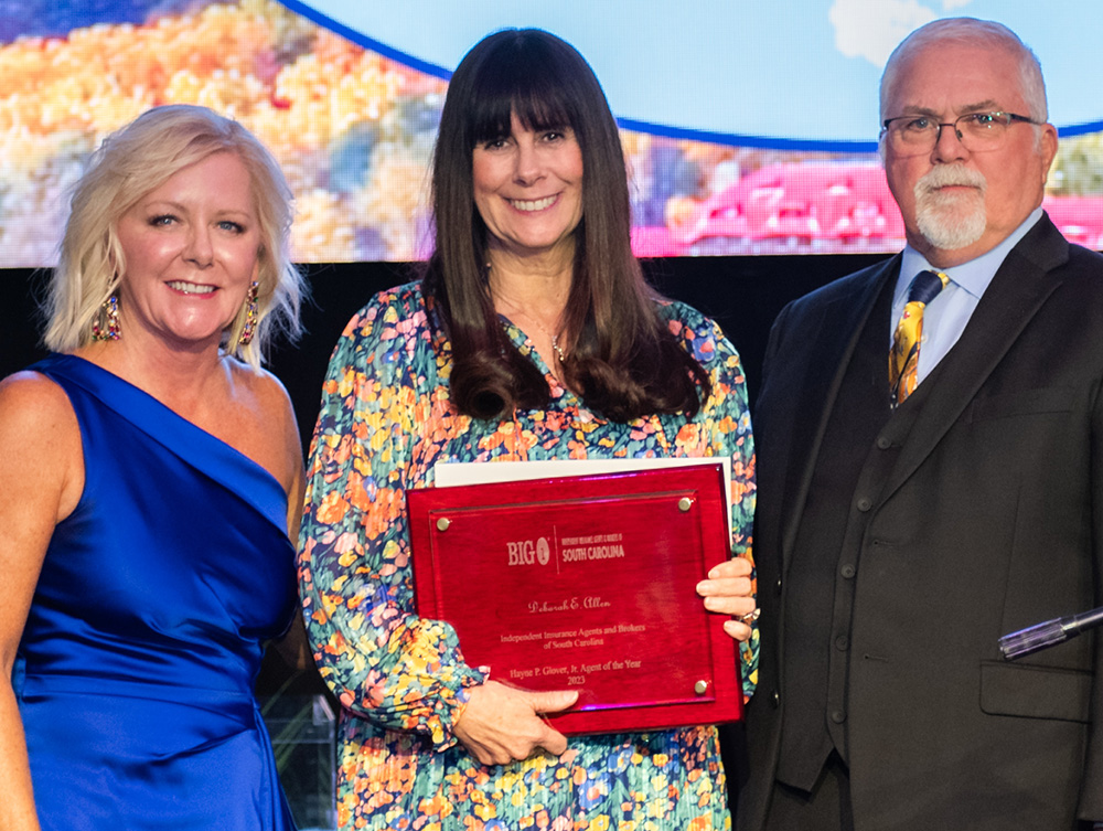 Deborah Allen is the 2023 Agent of the Year, posing with Chair of the Board Tonya THomason on the left and Gary Cornell of AFCO Credit Corporation (award sponsor)  on the right.