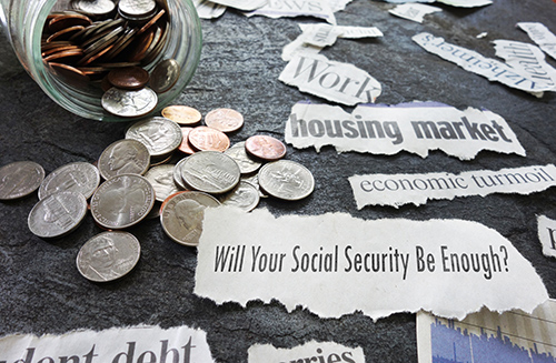 Close up of an overturned piggy bank with the ripped newspaper headline "Will your social security be enough?"