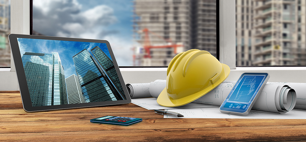 View of the desk of a commercial construction manager's office overlooking project grounds